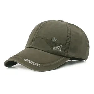Detail of army green washed cotton baseball cap with GSIOR embroidery and metal leaf badge