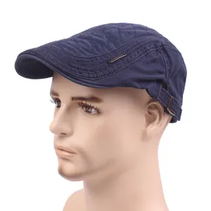 Dark blue newsboy cap with quilted pattern and metal buckle shown on a male head model