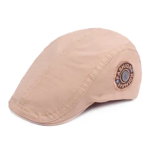 Classic cotton flat cap in light khaki with vintage embroidery badge and metal button