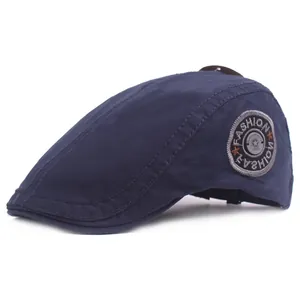 Classic navy blue cotton flat cap with a side embroidered badge and metal star detail