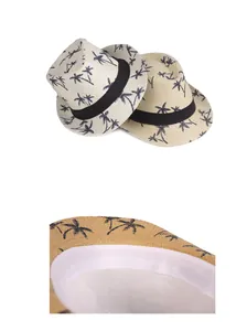 Detail of breathable straw sun hat featuring coconut tree prints and internal sweatband