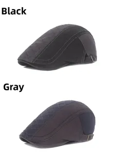 Detail view of cotton beret hats in black and grey with quilted stitching and metal buckle