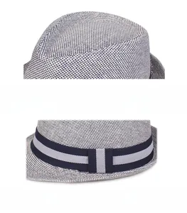 Detail of breathable woven mesh fedora hat featuring blue and white grid texture and striped band