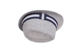 Close-up of the woven straw fedora texture with a navy and grey striped ribbon band