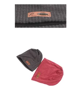 Close-up of knit beanies featuring leather H5 patch and fishbone metal ornaments