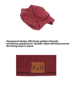 Detail view of hexagonal knit beanie with stitched brown leather label and double stitching