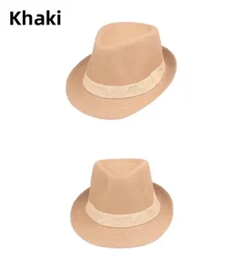 Detail of khaki straw fedora hat featuring a woven texture and decorative band