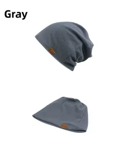 Detail view of grey knit beanie with F&S leather patch showing texture and elasticity