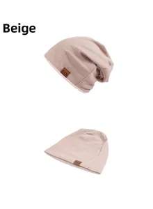 Detailed view of beige ribbed knit beanie featuring a premium brown leather F&S logo patch