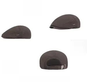 Detail of dark coffee winter flat cap showing metal logo and breathable mesh back