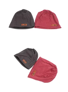 Detail of dark grey and rose red knit beanies featuring textured stripes and leather patches