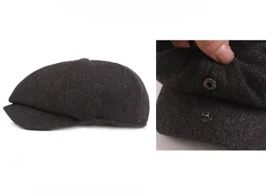 Detail of grey herringbone newsboy cap showing the warm fleece lining and metal button