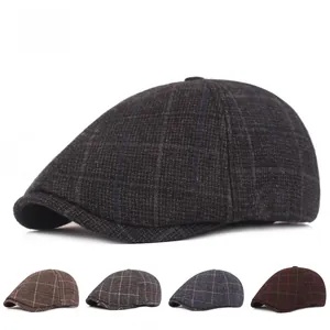 Detailed view of men's vintage plaid beret hats in various classic color patterns