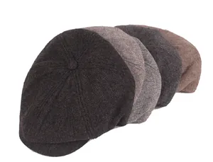 Detail of herringbone wool pattern on various colored newsboy caps with top button