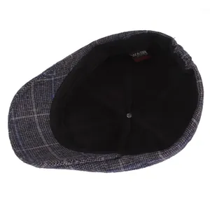 Interior view of men's plaid flat cap showing black lining and woven brand label