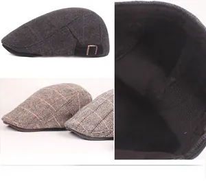 Detail view of plaid newsboy cap with metal buckle and soft inner lining texture