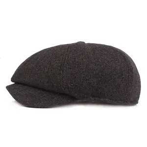 Detail view of the brown herringbone pattern and texture on this vintage newsboy cap