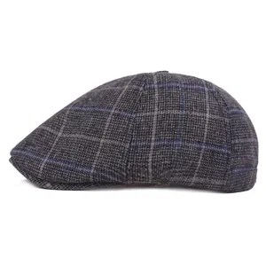 Side view detail of a classic grey plaid flat cap with thick wool blend texture