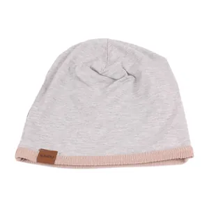 Gray knitted beanie with a khaki ribbed brim and a leather fashion tag for men and women