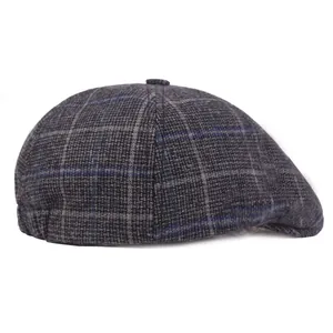 Close-up of grey plaid tweed flat cap showing classic check pattern and wool texture