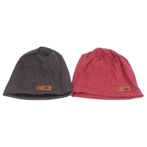 Knitted beanie set in dark grey and red colors with a decorative leather logo patch