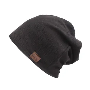 Dark brown ribbed knit beanie with leather F & S logo patch on a plain white background