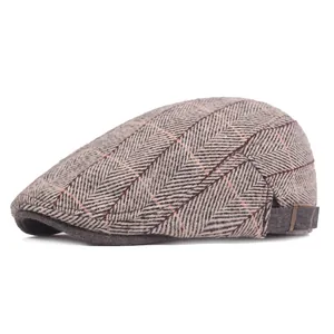 Close-up of herringbone pattern and metal adjustment buckle on the classic flat cap
