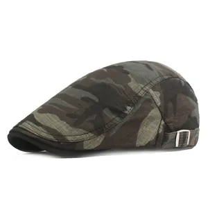 Detail of camouflage flat cap showing metal side buckle and twill canvas texture
