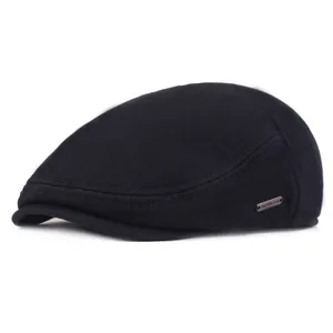 Close-up of thick winter ivy cap fabric texture with a premium metal brand logo