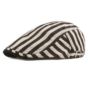 Detail of black and white striped flat cap showing cotton-linen texture and side metal buckle