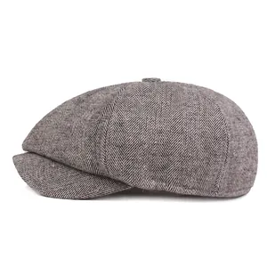 Detail of grey herringbone newsboy cap fabric texture and classic eight-panel crown design