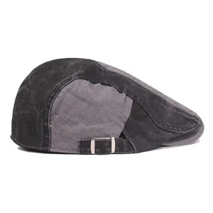 Detail of vintage washed cotton beret with contrast paneling and silver metal buckle