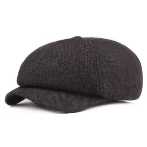 Detail of grey herringbone tweed fabric texture on a vintage British newsboy cap