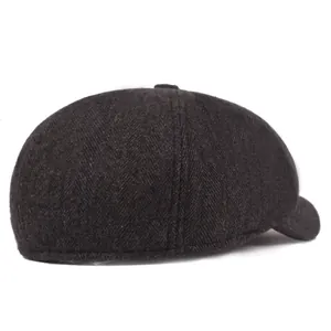 Detail shot of heavy grey wool fabric with classic herringbone weave on newsboy cap