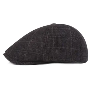 Detail of classic dark grey plaid Ivy cap with thick wool-like textured fabric