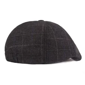Detail of grey plaid flat cap showing blue grid wool blend texture and elastic back strap