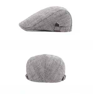 Detail of grey herringbone flat cap with metal side buckle and precise stitching