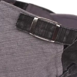 Macro detail of adjustable silver metal buckle and textured fabric on vintage beret cap