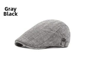 Detailed macro of the grey black herringbone pattern and metal buckle on the flat cap