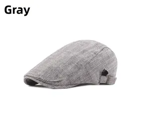 Detail showing the gray herringbone fabric and side metal buckle of the flat cap