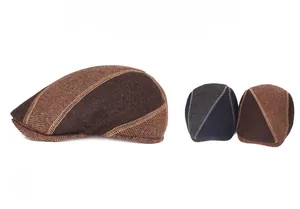 Close-up of wool herringbone flat caps in brown, grey and navy with panel stitching