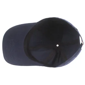 Inside view of navy cotton baseball cap featuring 100% cotton label and metal strap
