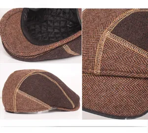 Detail of brown herringbone wool flat cap with quilted lining and reinforced stitching