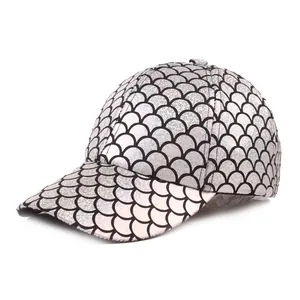 Close-up of reflective silver mermaid fish scale pattern on textured baseball cap