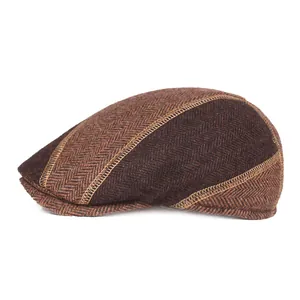 Detail of wool ivy cap featuring herringbone pattern and golden contrast stitching
