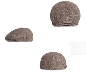 Detail of coffee plaid cotton newsboy hat featuring metal shield buckle and 3D tailoring