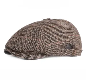 Detail view of adjustable back strap and brown tweed plaid pattern on the beret hat