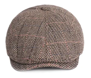 Macro detail of brown plaid tweed newsboy hat with textured fabric and short brim