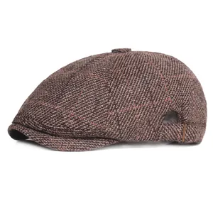 Detail of tweed check newsboy cap with vintage brown pattern and brass metal side buckle