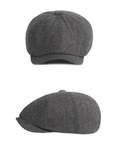 Close-up of dark grey herringbone newsboy cap with classic eight-panel construction